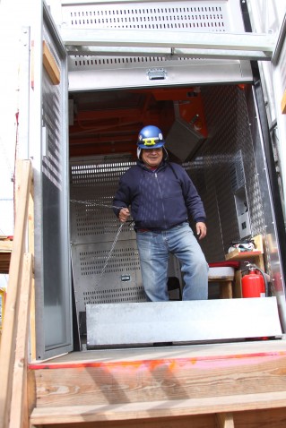 Operating Engineer Wilfredo Gomez captains the temporary elevator on the easternmost set of towers.